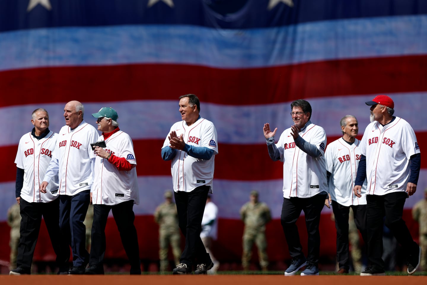 Members of the 1986 Boston Red Sox walk onto the field for the Opening Day ceremony.