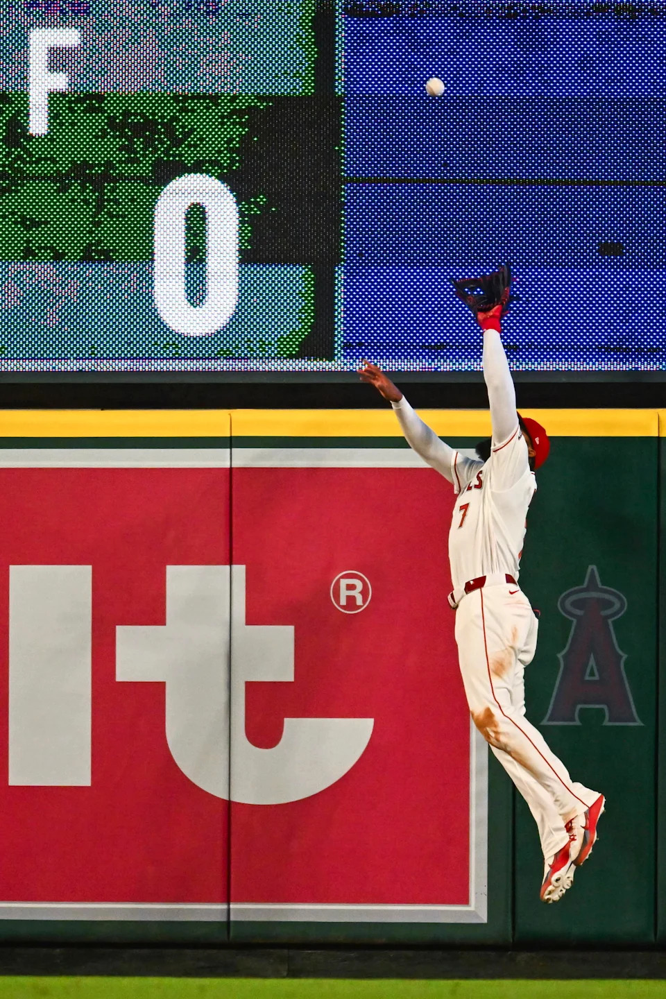 Los Angeles Angels right fielder Jo Adell jumps to rob Seattle Mariners first baseman Josh Naylor of a potential home run in a game Saturday at Angel Stadium in Anaheim, Calif. | Jonathan Hui/Imagn Images.