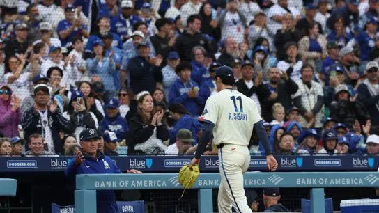 Fans acknowledge Los Angeles Dodgers starting pitcher Roki Sasaki (11) after a pitching change against the Chicago Cubs during the sixth inning at Dodger Stadium. 