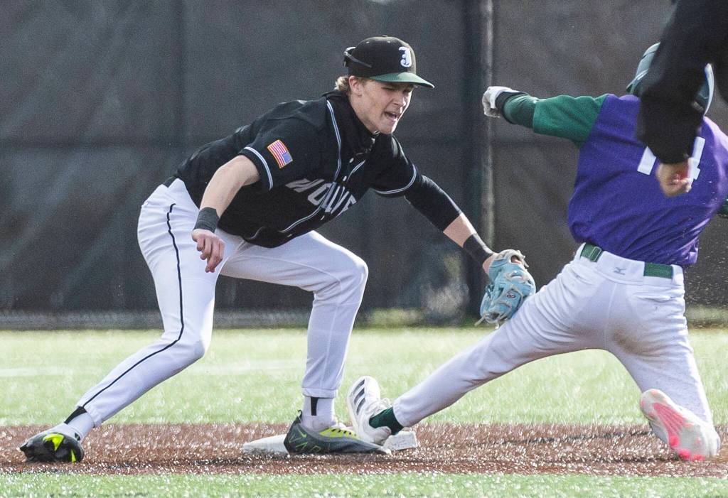 Jackson’s Austin Halvorson tags Edmonds-Woodway’s Toshi Gilginas as he slides into second for the out during the game on Wednesday, April 2, 2025 in Edmonds, Washington. (Olivia Vanni / The Herald)