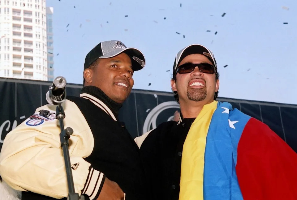 Then Chicago White Sox General Manager and Executive Vice-President Kenny Williams and manager Ozzie Guillén, who is draped in the flag of Venezuela, celebrate during the team’s 2005 World Series victory parade in Chicago. Getty Images
