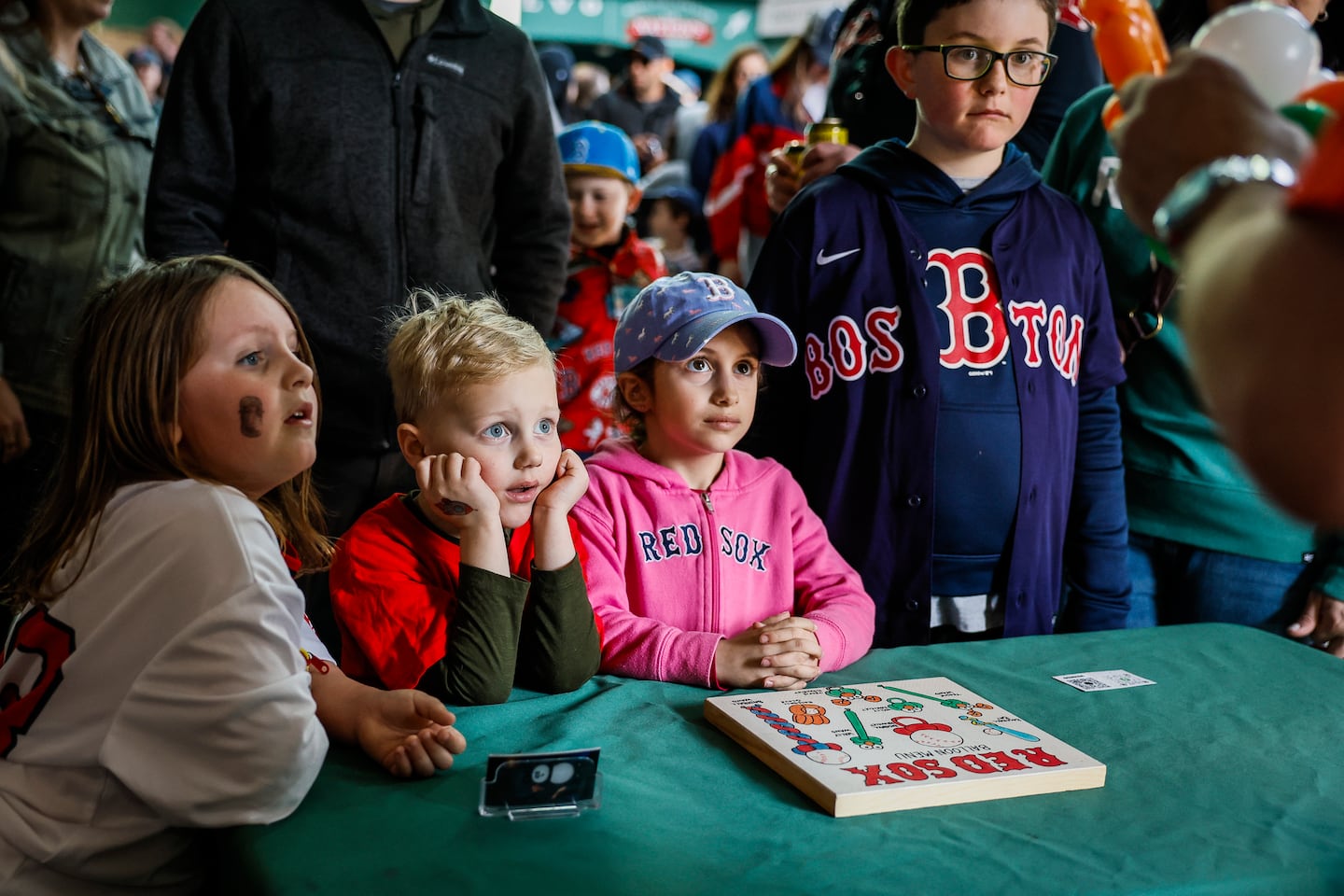 Children watch as balloon art is made along the concourse.
