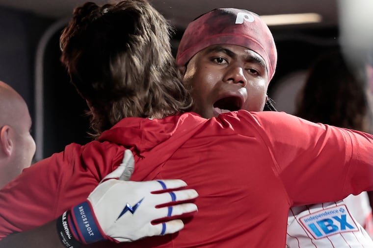 Phils Bryson Stott (left) hugs Felix Reyes after Reyes hit a solo homerun in the second inning of the Atlanta Braves vs. Philadelphia Phillies baseball game at Citizens Bank Park in Philadelphia on Saturday, April 18, 2026. It was Reyes first at bat in the major league.