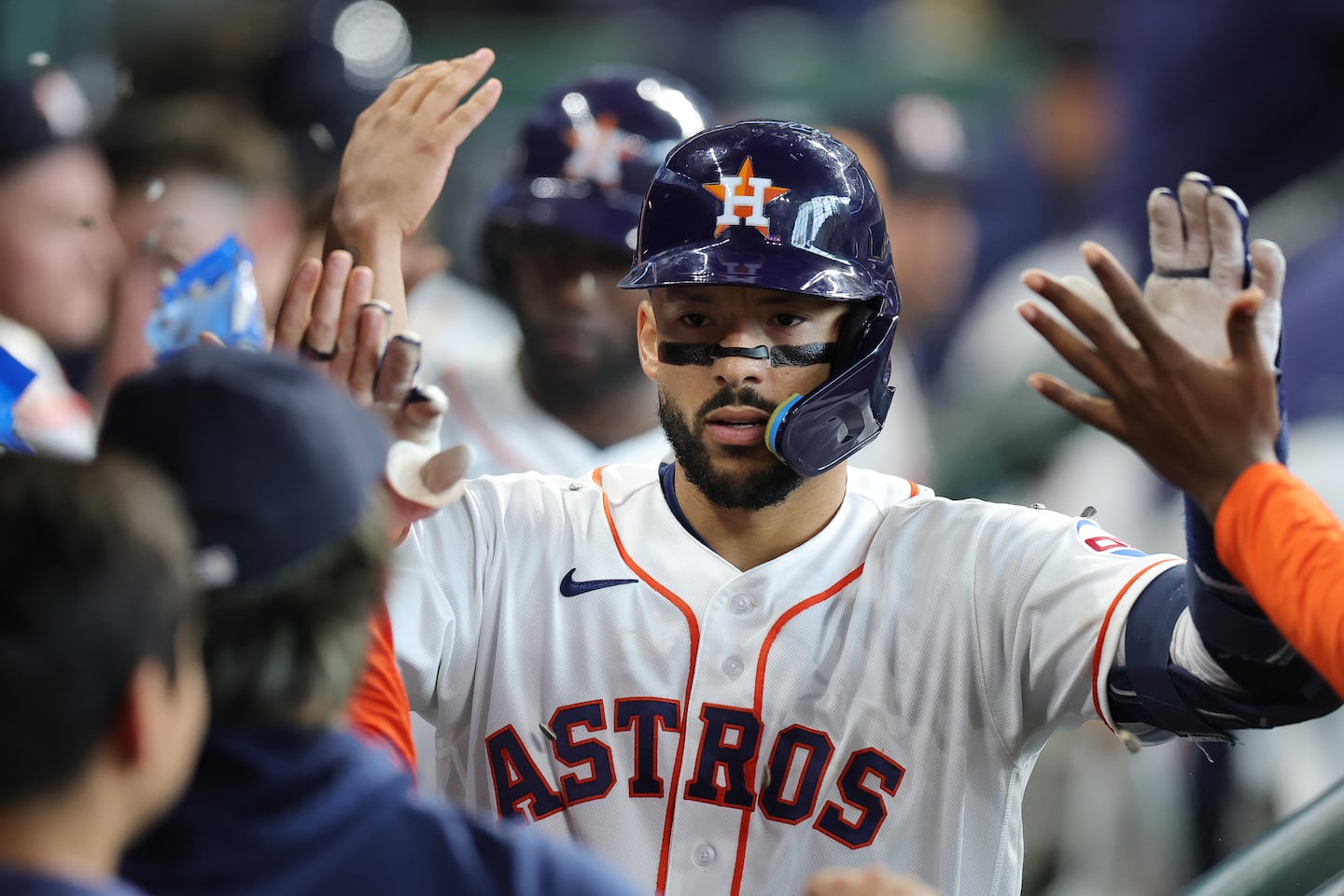 Carlos Correa was greeted by his Astros teammates after hitting a three-run homer in the fifth inning.