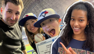 In the foreground of the image is Kids News contributor Maya Endale pointing to the background. In the background is a boy with his parents holding a baseball and smiling with glee.