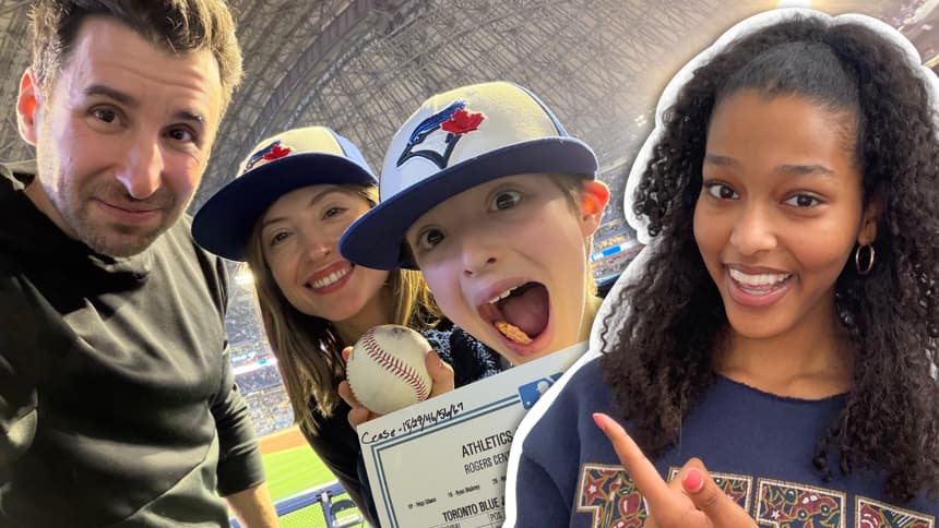 In the foreground of the image is Kids News contributor Maya Endale pointing to the background. In the background is a boy with his parents holding a baseball and smiling with glee.