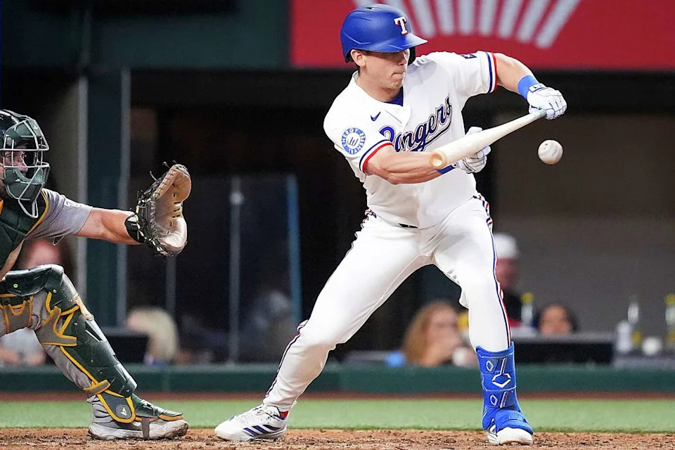 Texas Rangers outfielder Sam Haggerty drops a bunt for a single during the third inning of a baseball game against the Athletics at Globe Life Field on Saturday, April 25, 2026, in Arlington. (Smiley N. Pool/The Dallas Morning News)