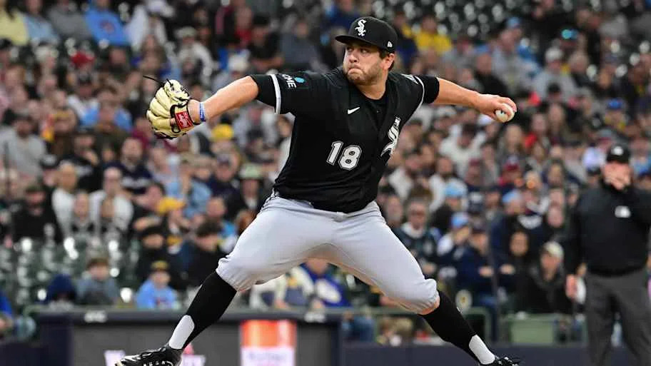 Anthony Kay throws a baseball in a black unifor