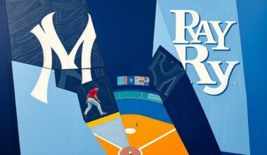 A fractured, geometric painting depicting a baseball game between the New York Yankees and Tampa Bay Rays, with sharp overlapping planes in navy blue, gray, and powder blue hues.