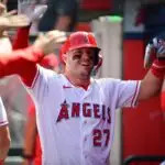 Apr 5, 2026; Anaheim, California, USA; Los Angeles Angels center fielder Mike Trout (27) is greeted after scoring a run against the Seattle Mariners during the third inning at Angel Stadium. Mandatory Credit: Gary A. Vasquez-Imagn Images