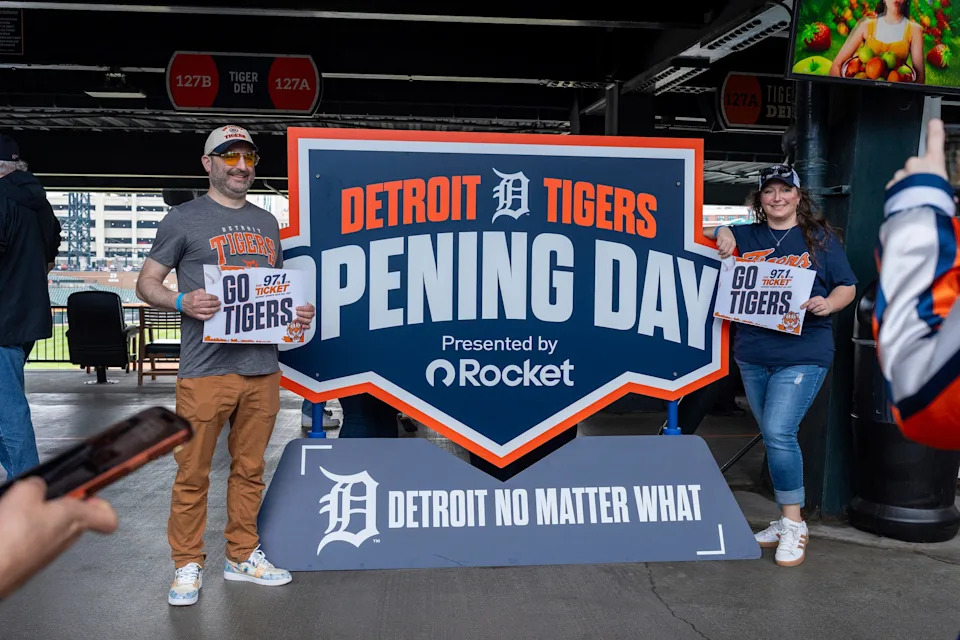 Fans take a photo next to an Opening Day sign as the Detroit Tigers host the St. Louis Cardinals at Comerica Park in Detroit on Friday, April 3, 2026.
