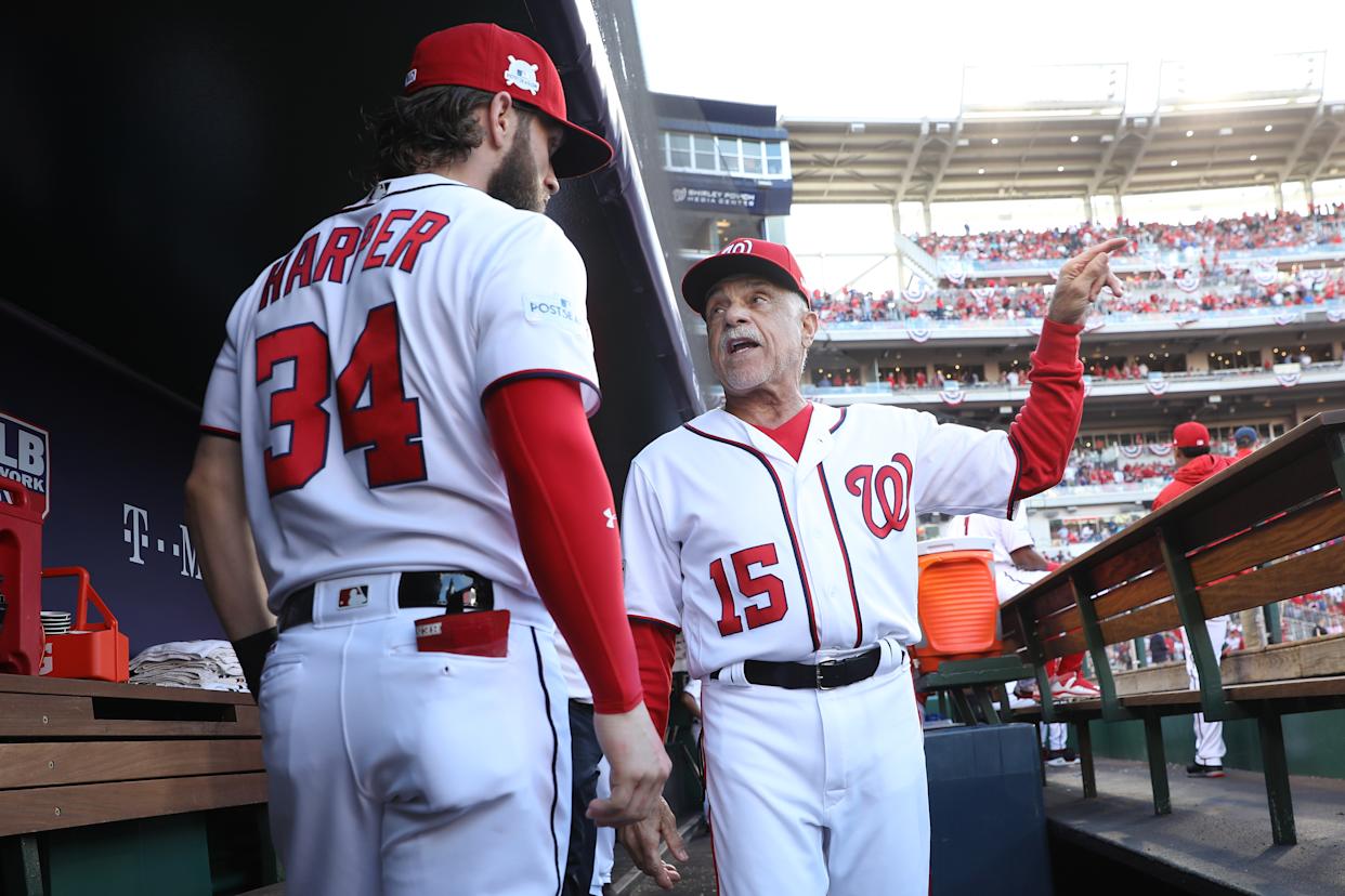 WASHINGTON, DC - OCTOBER 07: Bryce Harper #34 of the Washington Nationals and Davey Lopes #15 of the Washington Nationals stand in the dugout prior to game two of the National League Division Series against the Chicago Cubs at Nationals Park on October 7, 2017 in Washington, DC. (Photo by Win McNamee/Getty Images)