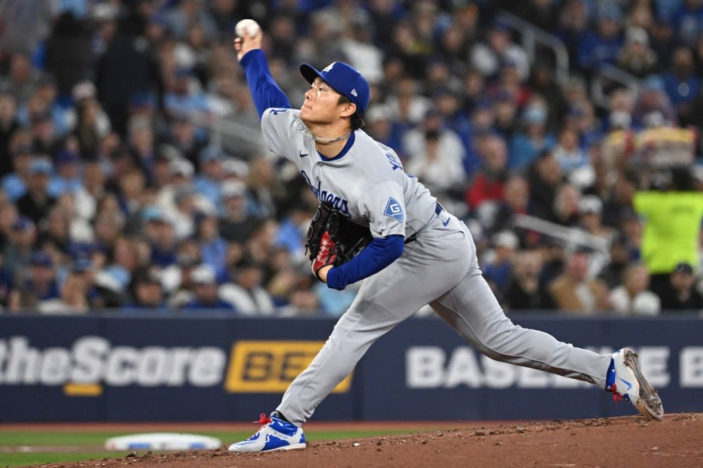 Los Angeles Dodgers starting pitcher Yoshinobu Yamamoto delivers a pitch against the Toronto Blue Jays in the second inning at Rogers Centre. IMAGN IMAGES via Reuters Connect