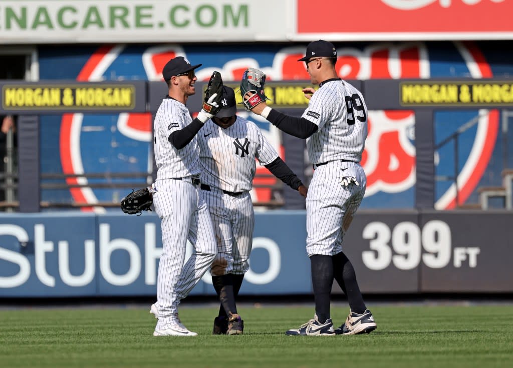 The Yankees outfielders celebrate the home opener win. Charles Wenzelberg/New York Post