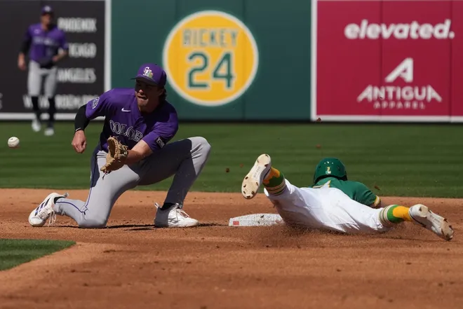 Mar 6, 2026; Mesa, Arizona, USA; Athletics third baseman Max Muncy (3) steals second base under the tag of Colorado Rockies shortstop Chad Stevens (39) in the first inning at Hohokam Stadium.