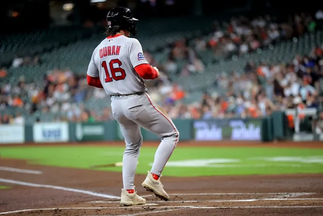 Apr 1, 2026; Houston, Texas, USA; Boston Red Sox left fielder Jarren Duran (16) crosses home plate to score a run against the Houston Astros during the first inning at Daikin Park.