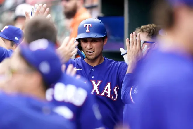 Apr 1, 2026; Baltimore, Maryland, USA; Texas Rangers shortstop Corey Seager (5) greeted by teammates (4) after his eighth inning solo home run against the Baltimore Orioles at Oriole Park at Camden Yards.