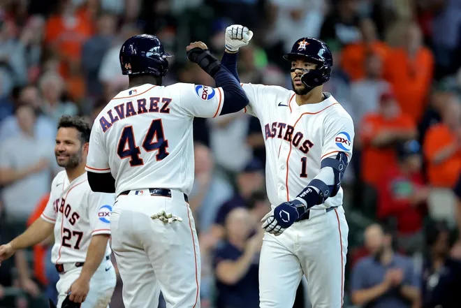 Apr 1, 2026; Houston, Texas, USA; Houston Astros shortstop Carlos Correa (1) is congratulated by Houston Astros designated hitter Yordan Alvarez (44) after hitting a three-run home run to left field against the Boston Red Sox during the fifth inning at Daikin Park.