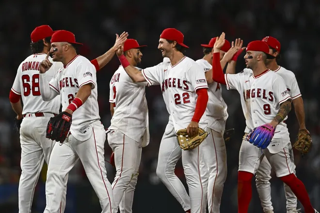 Apr 4, 2026; Anaheim, California, USA; Los Angeles Angels center fielder Bryce Teodosio (22), Los Angeles Angels center fielder Mike Trout (27), Los Angeles Angels shortstop Zach Neto (9) and other teammates celebrate after defeating the Seattle Mariners 1-0 during the ninth inning at Angel Stadium.