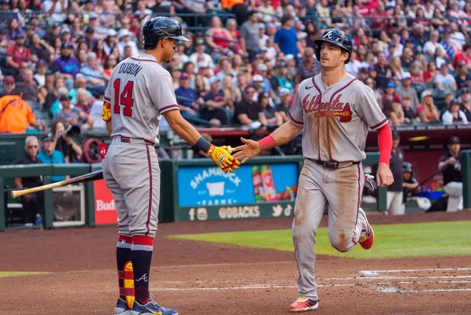 Apr 4, 2026; Phoenix, Arizona, USA; Atlanta Braves infielder Matt Olson (28) celebrates with infielder Mauricio Dubon (14) after scoring in the second inning of a game against the Arizona Diamondbacks at Chase Field.