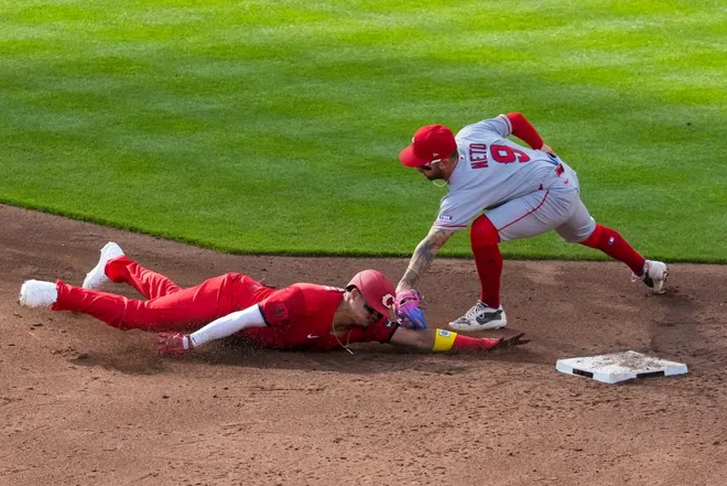 Apr 11, 2026; Cincinnati, Ohio, USA; Cincinnati Reds outfielder Noelvi Marte (4) is tagged out by Los Angeles Angels shortstop Zach Neto (9) as he attempts to steal second base in the third inning at Great American Ball Park.