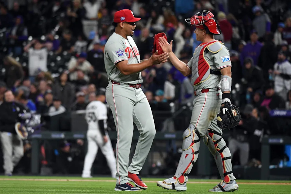 Apr 4, 2026; Denver, Colorado, USA; Philadelphia Phillies pitcher Jhoan Duran (59) and catcher J.T. Realmuto (10) celebrate after a win against the Colorado Rockies at Coors Field. Mandatory Credit: Christopher Hanewinckel-Imagn Images