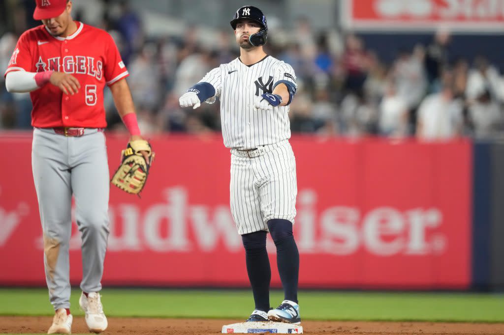 Randal Grichuk, right, reacts after hitting a double during the eighth inning of a baseball game against the Los Angeles Angels, Tuesday, April 14, 2026. AP