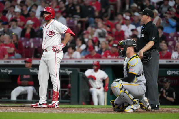 Cincinnati Reds third baseman Sal Stewart, left, waits for an Automated Ball-Strike System during the sixth inning of a baseball game Monday, March 30, 2026, in Cincinnati. (AP Photo/Kareem Elgazzar)