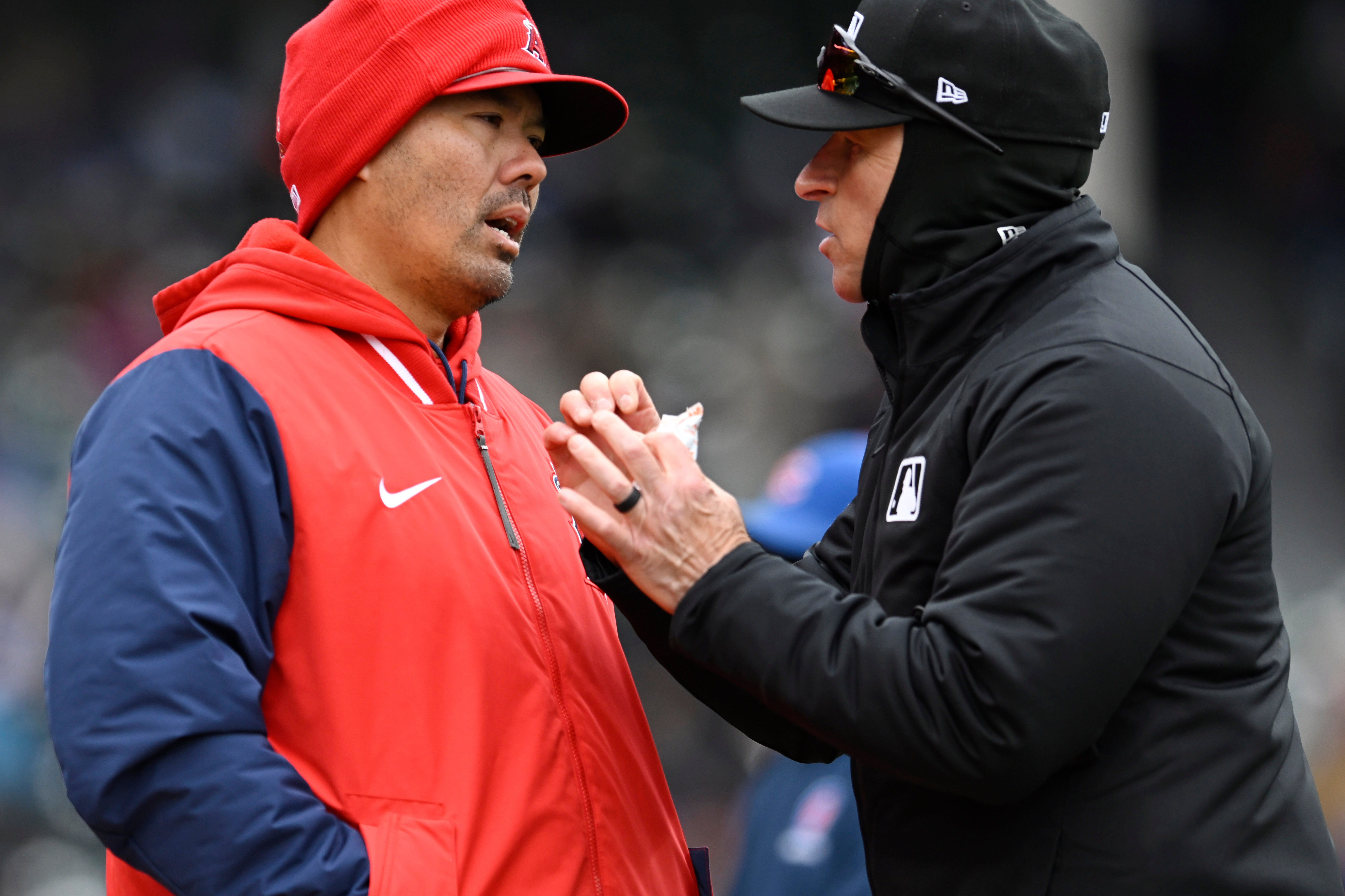 Angels manager Kurt Suzuki, left, attempts to challenge a play...