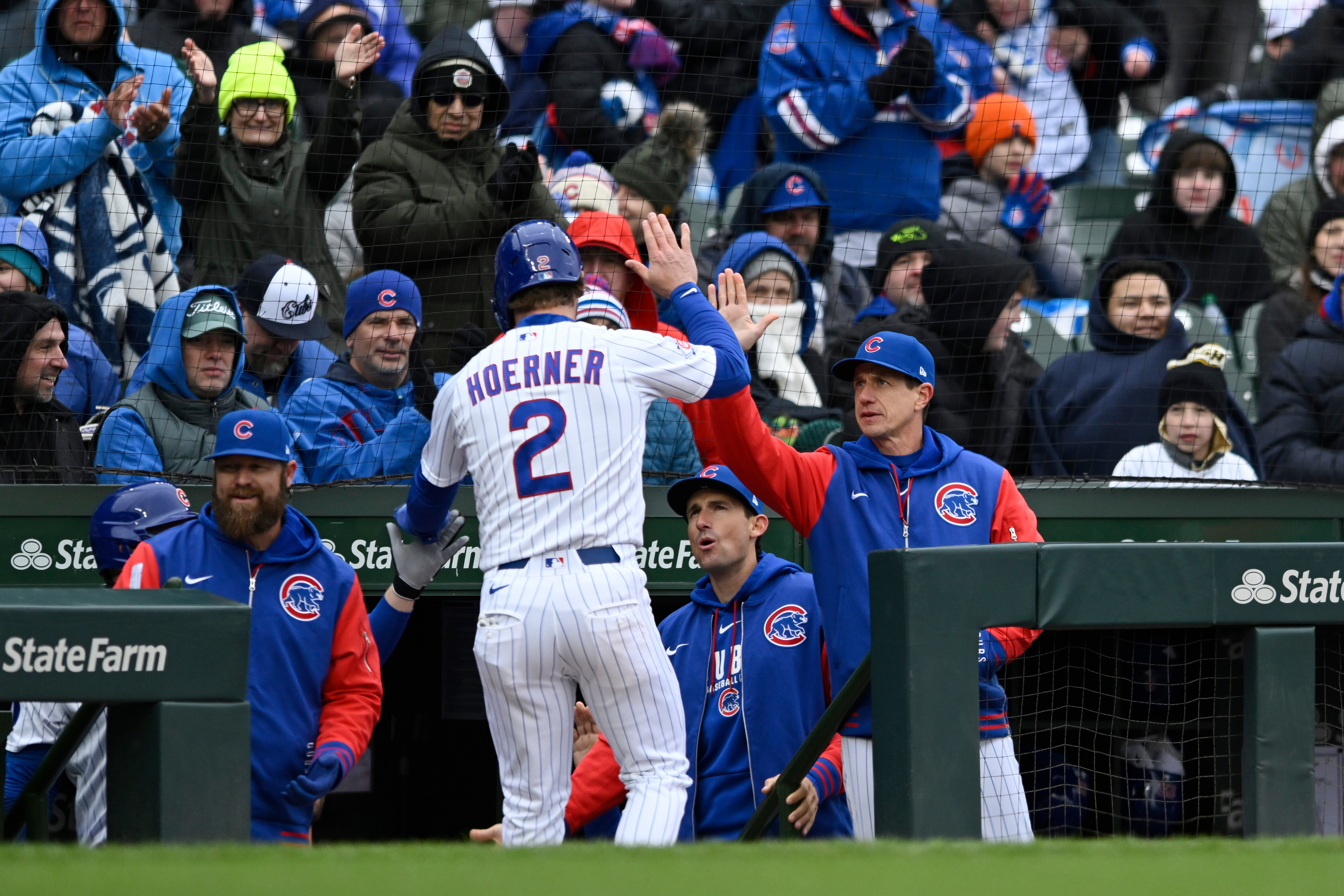 The Chicago Cubs’ Nico Hoerner (2) celebrates with Manager Craig...