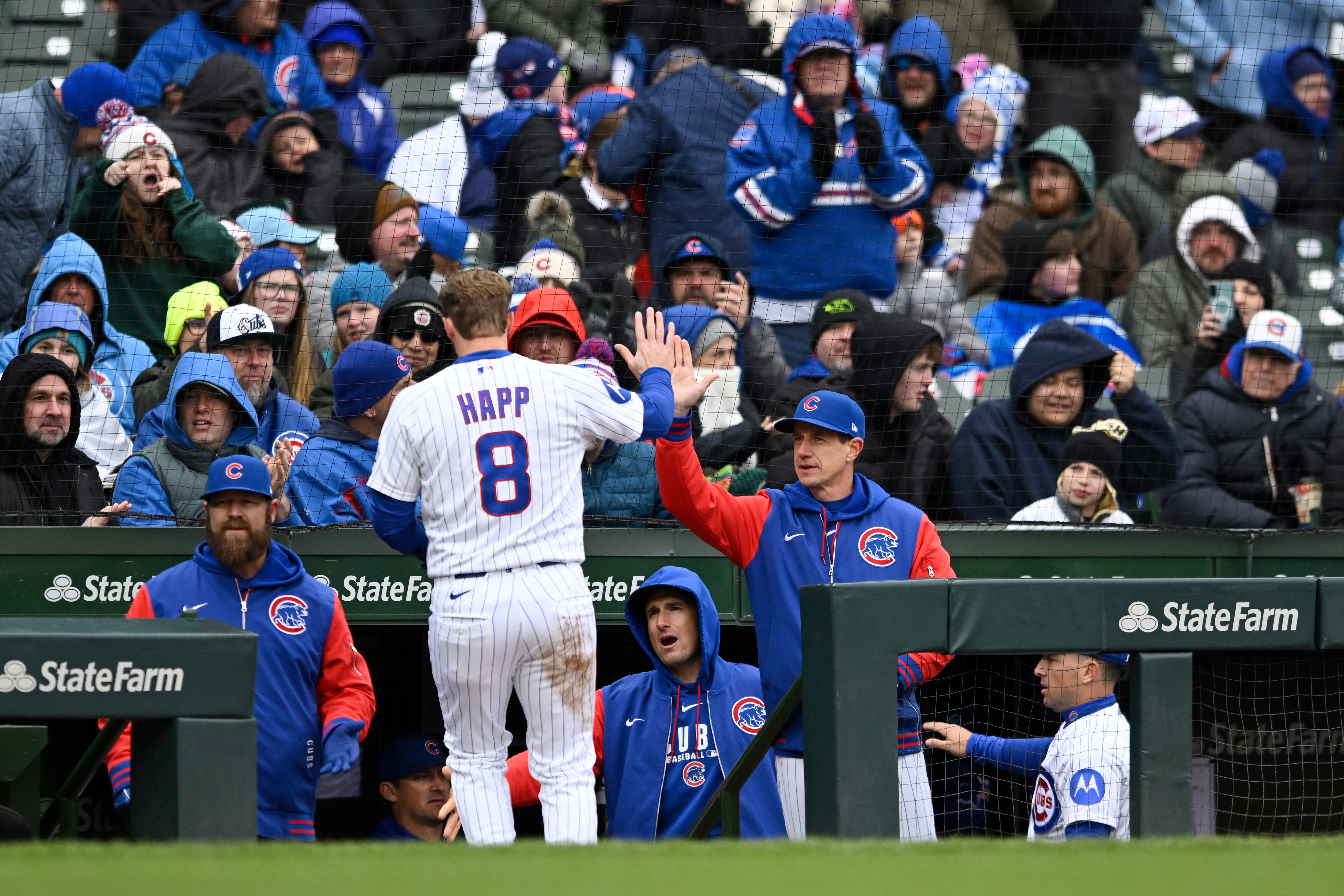 The Chicago Cubs’ Ian Happ (8) celebrates with Manager Craig...