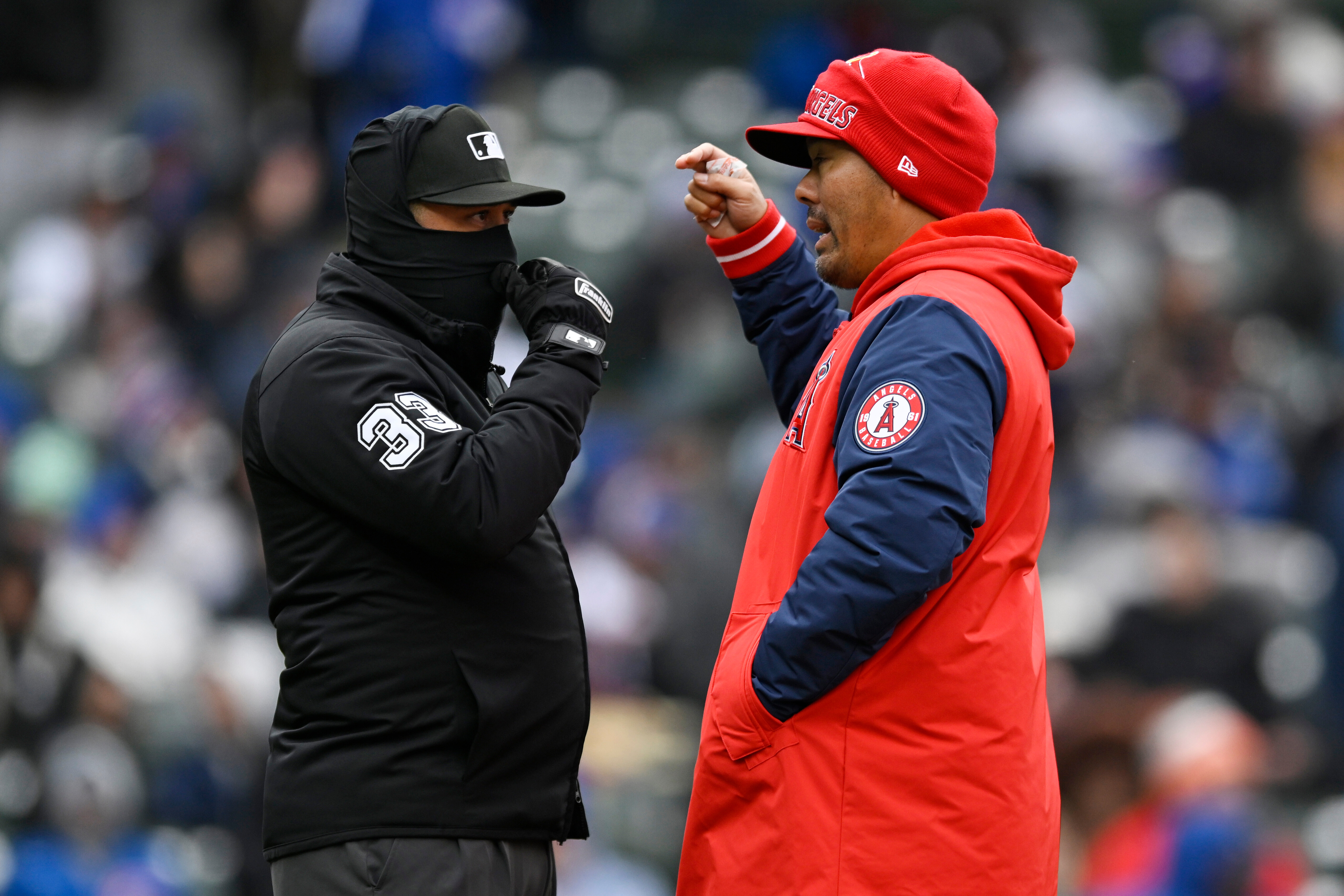 Angels manager Kurt Suzuki, right, talks with an umpire during...
