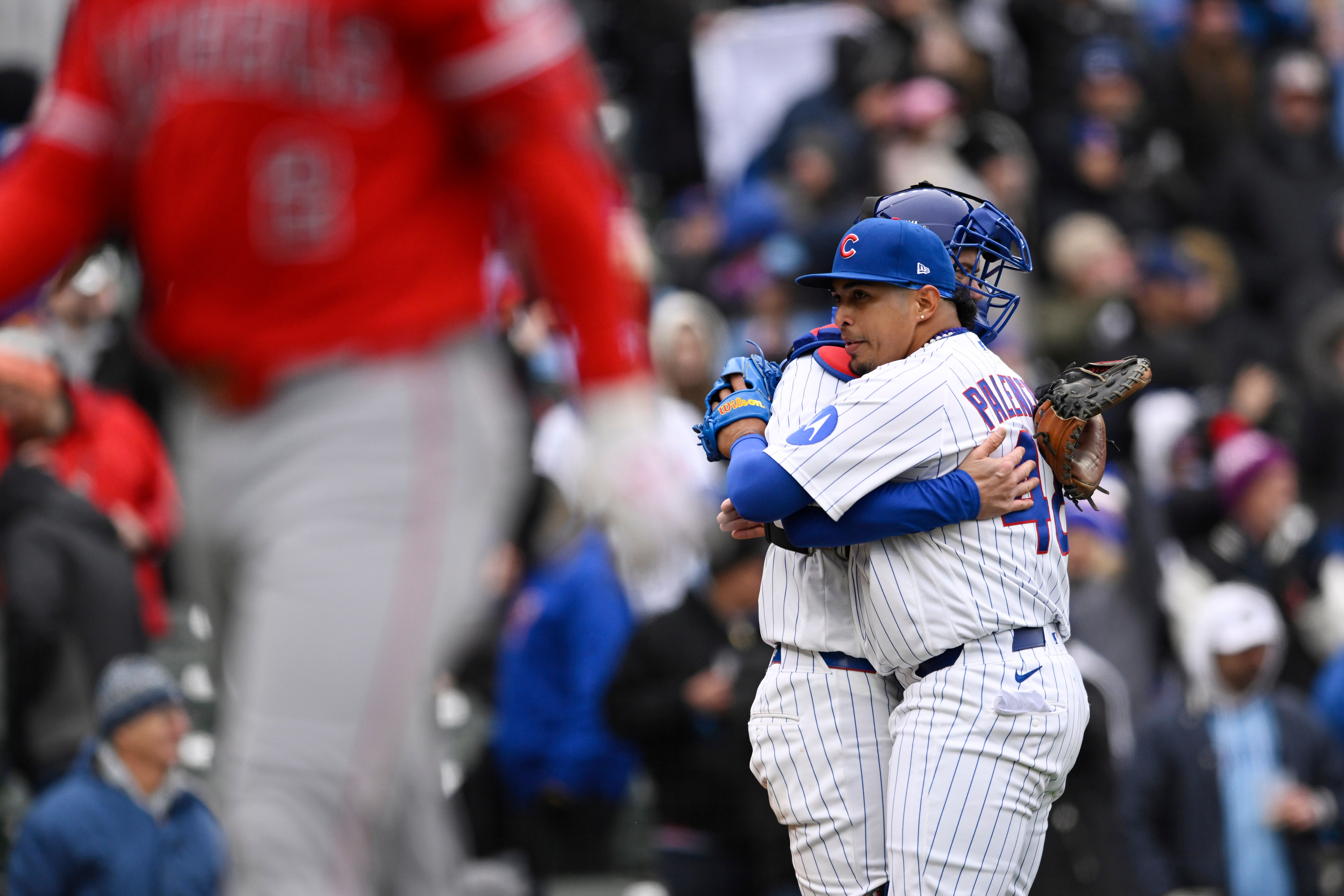 Chicago Cubs relief pitcher Daniel Palencia, right, hugs catcher Carson...