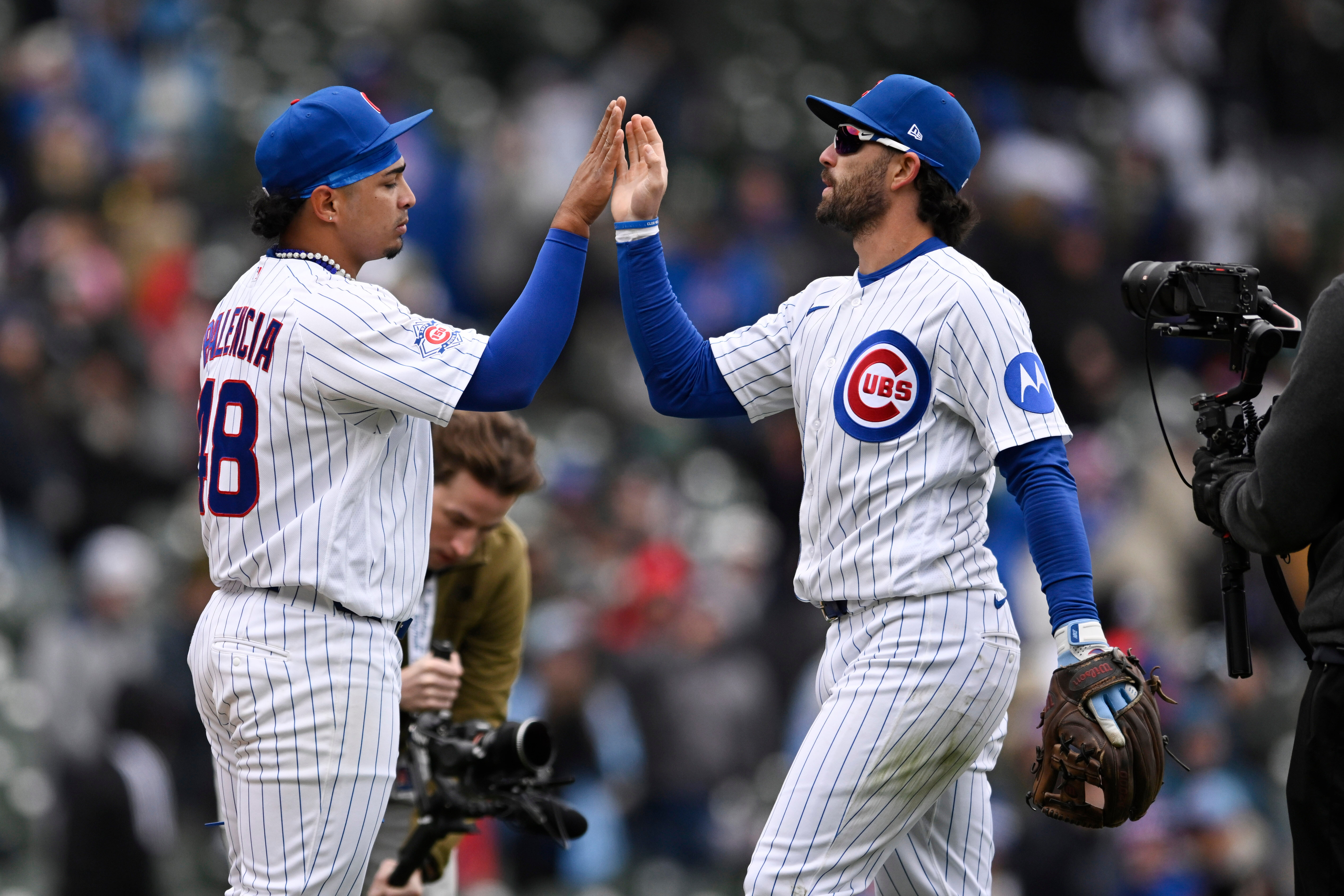 Chicago Cubs relief pitcher Daniel Palencia, left, celebrates with shortstop...