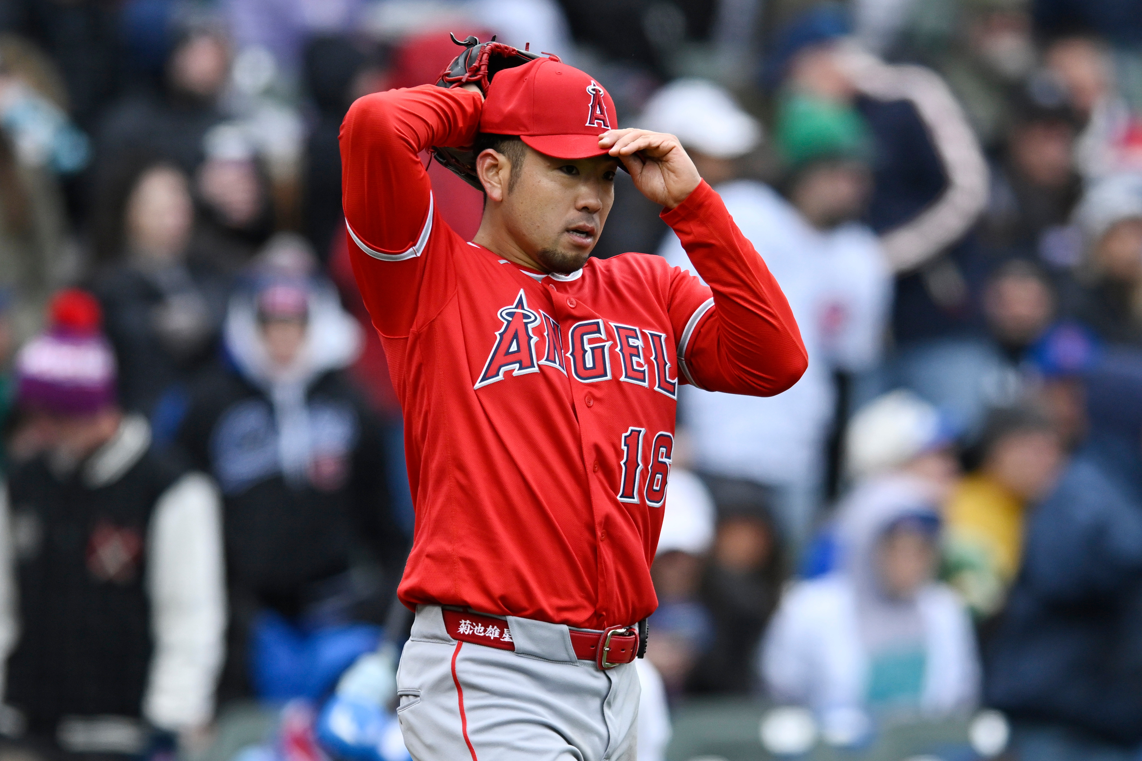 Angels starting pitcher Yusei Kikuchi reacts after giving up five...