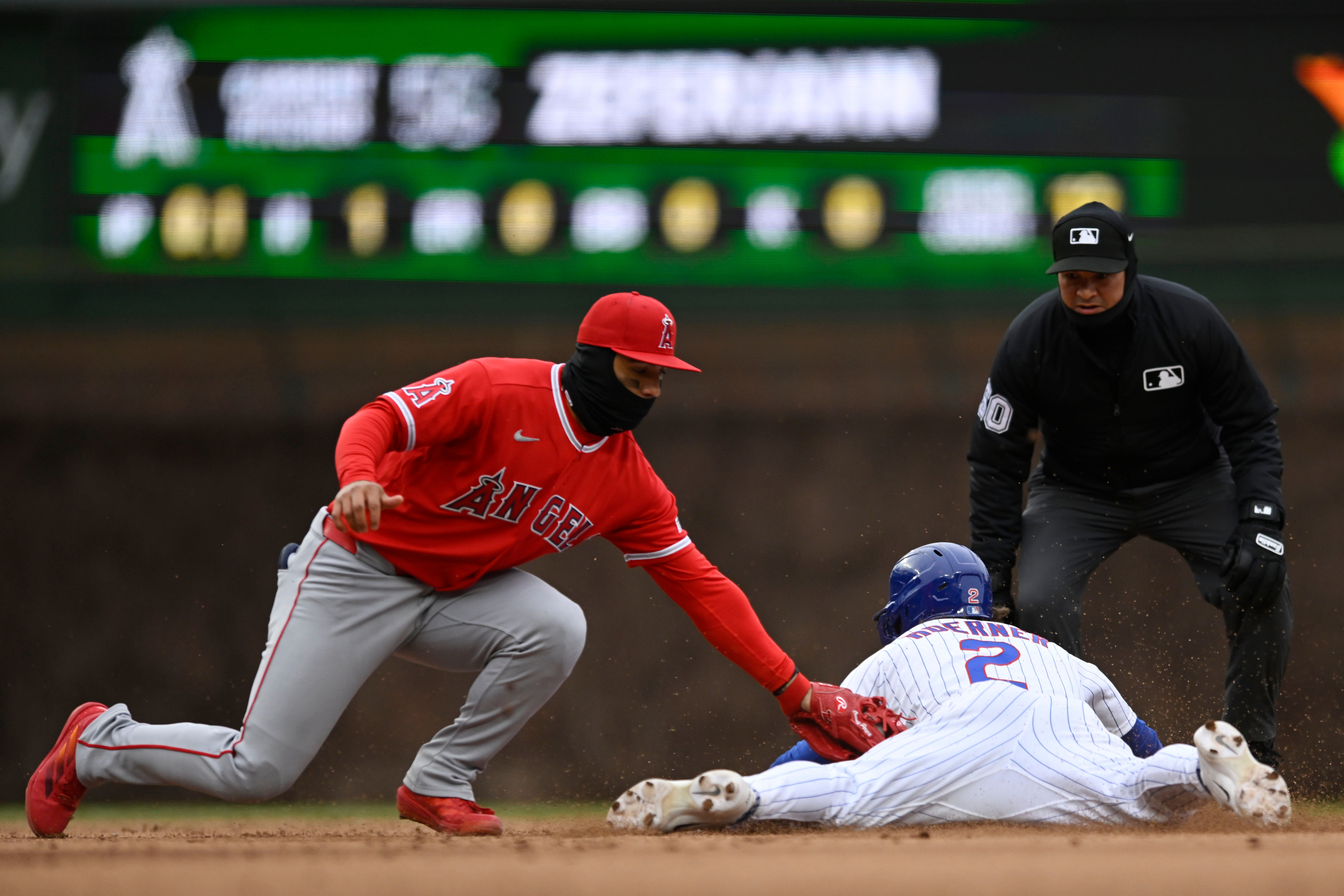 The Chicago Cubs’ Nico Horener, right, steals second base as...