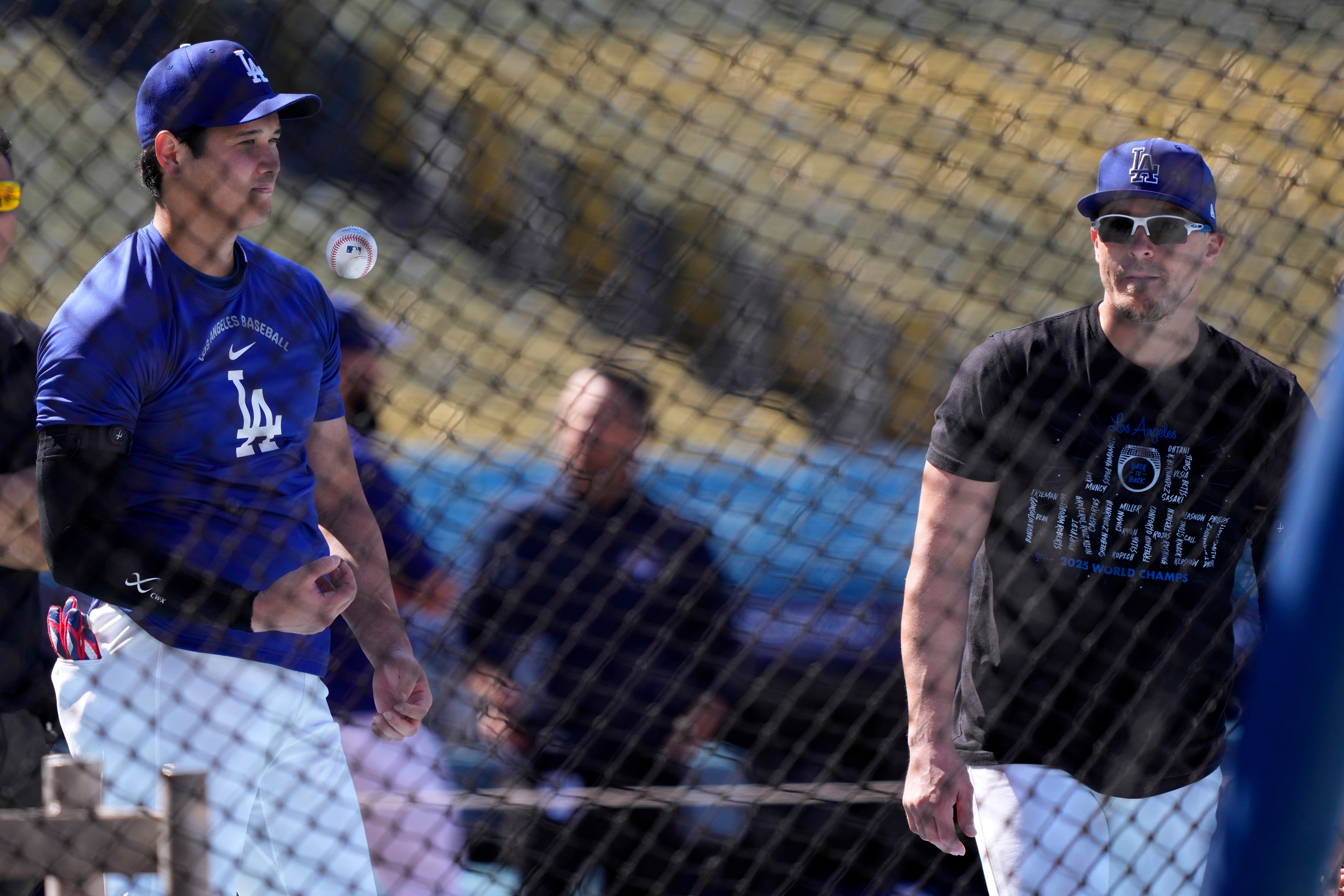Dodgers star Shohei Ohtani, left, talks with teammate KikÃ© HernÃ¡ndez...