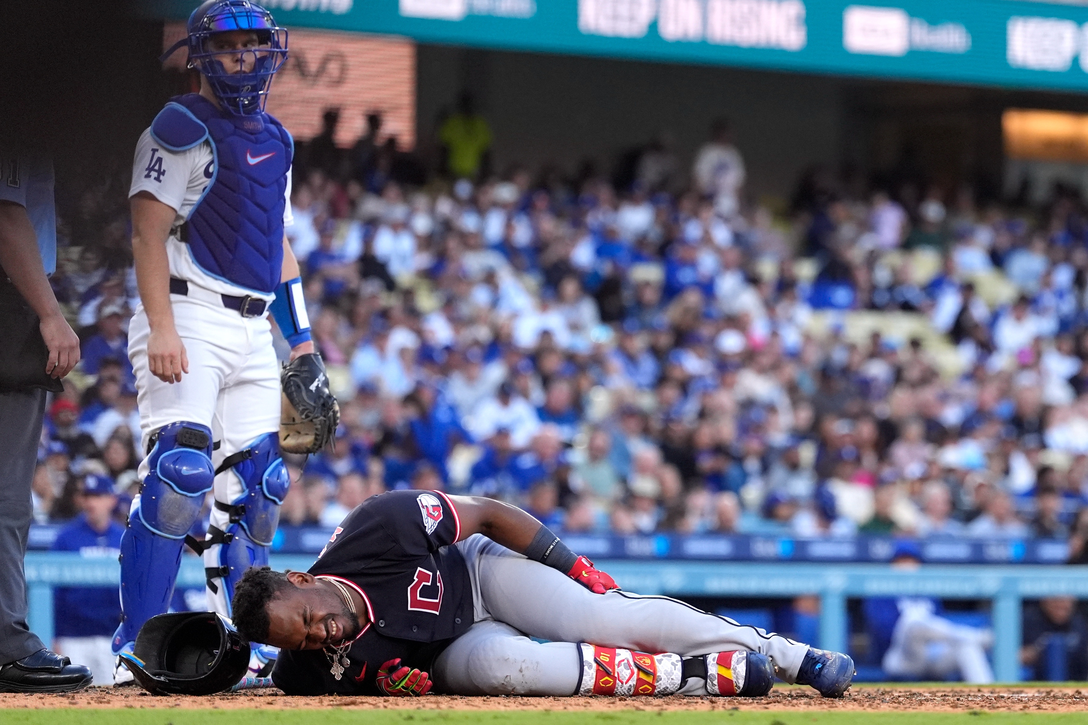 The Cleveland Guardians’ Angel Martinez writhes on the ground after...