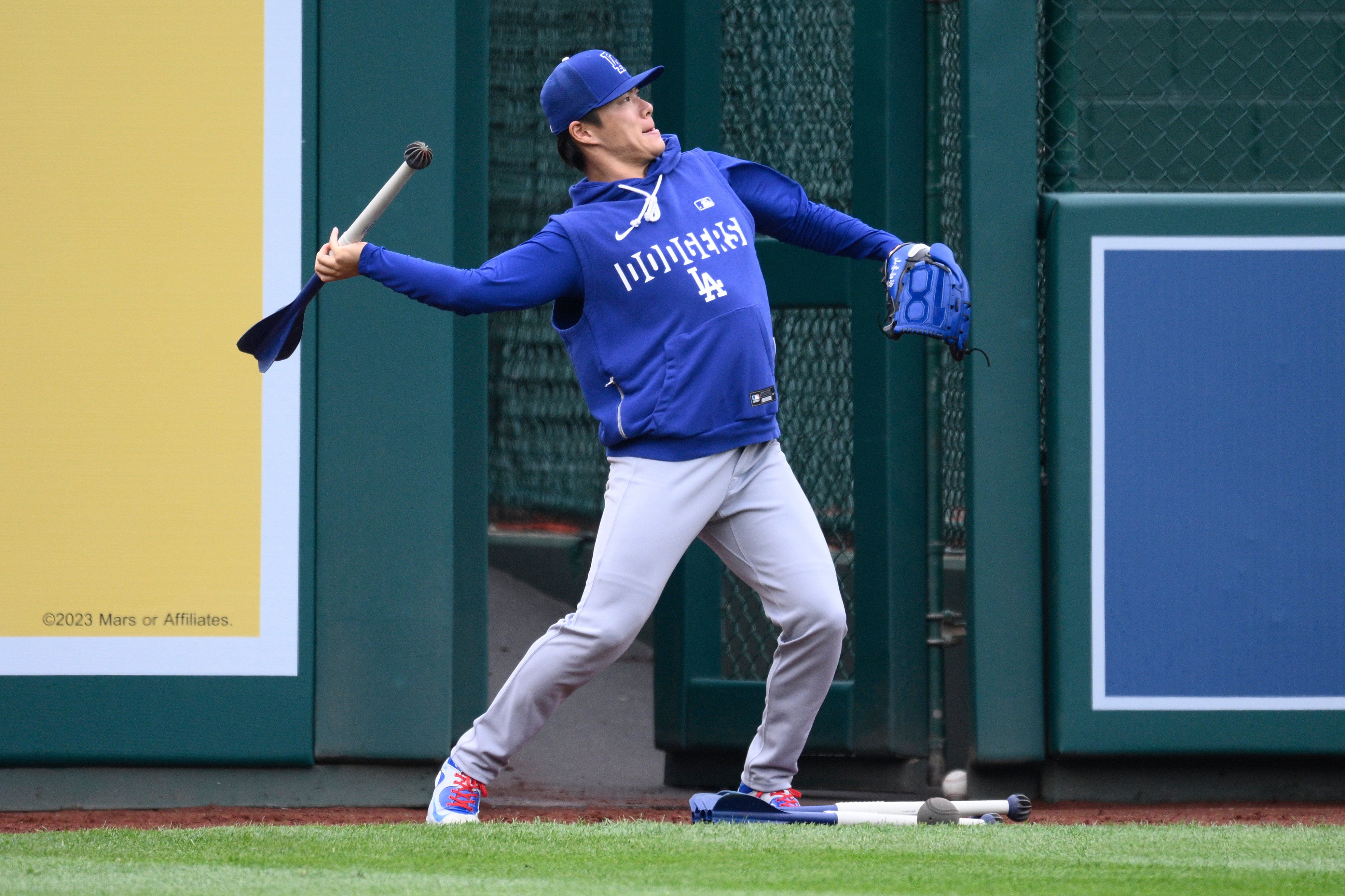 Dodgers pitcher Yoshinobu Yamamoto works out before a baseball game...