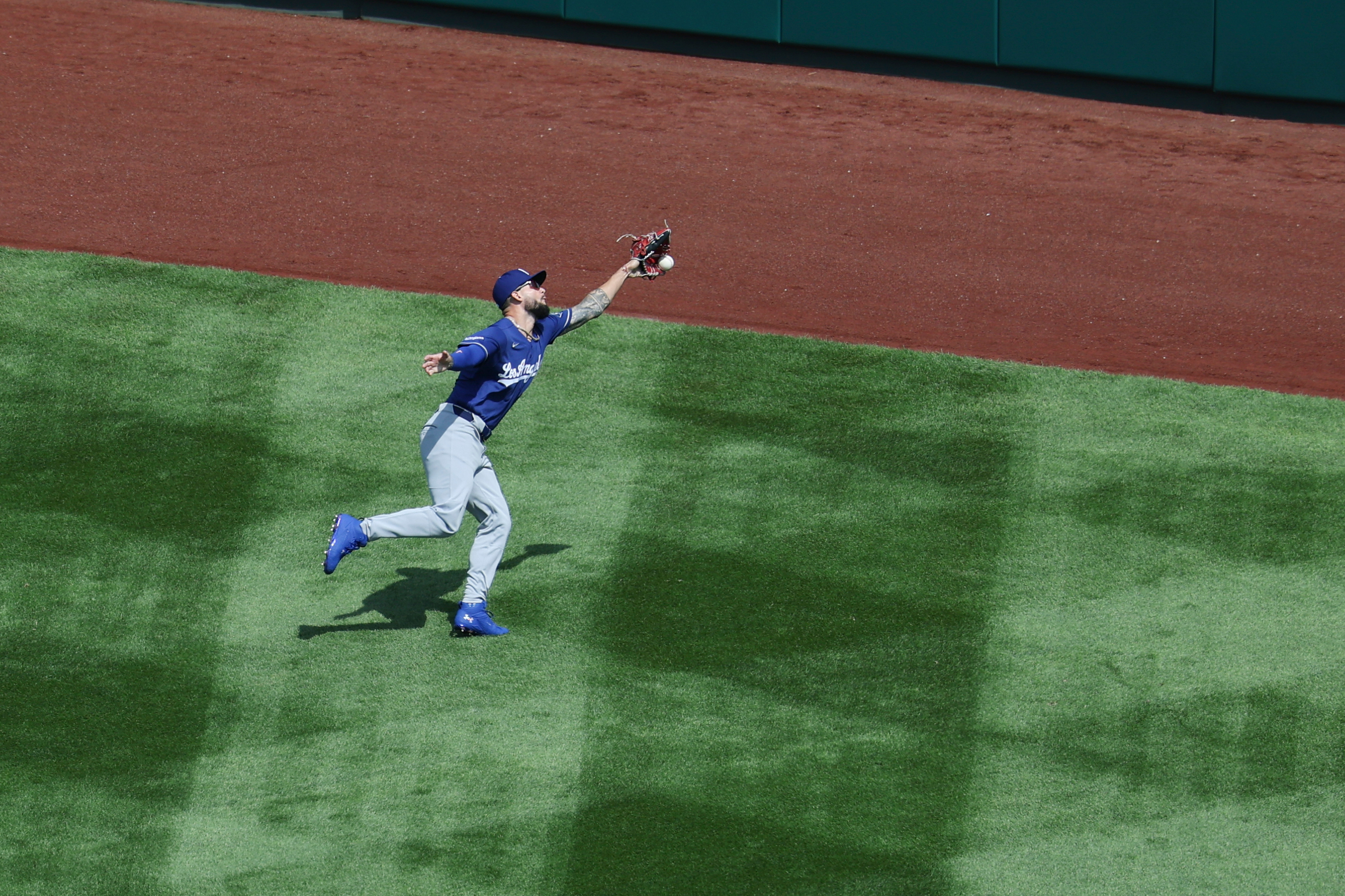 Dodgers center fielder Andy Pages attempts to catch a double...
