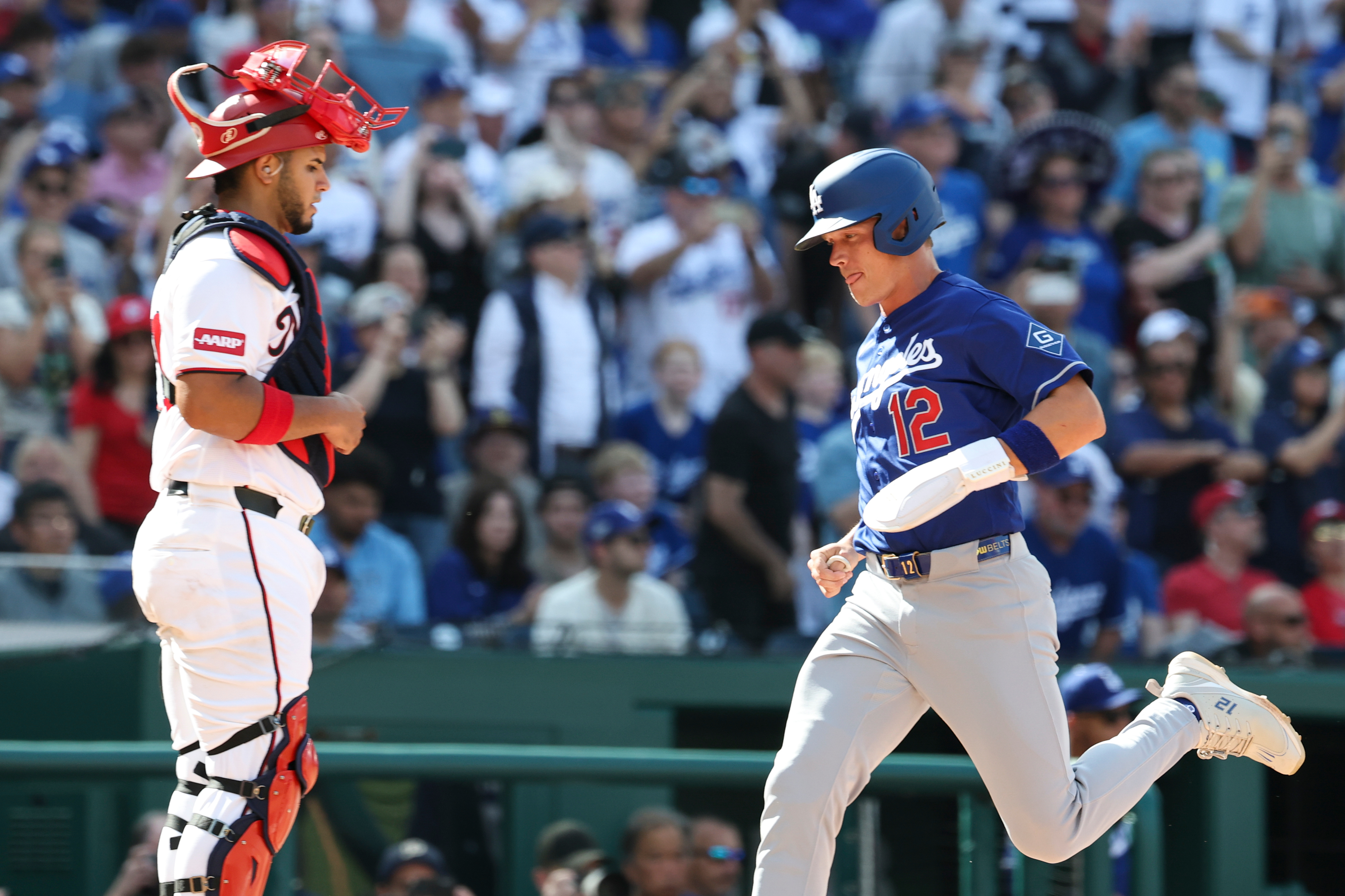 The Dodgers’ Alex Call (12) scores a run on a...