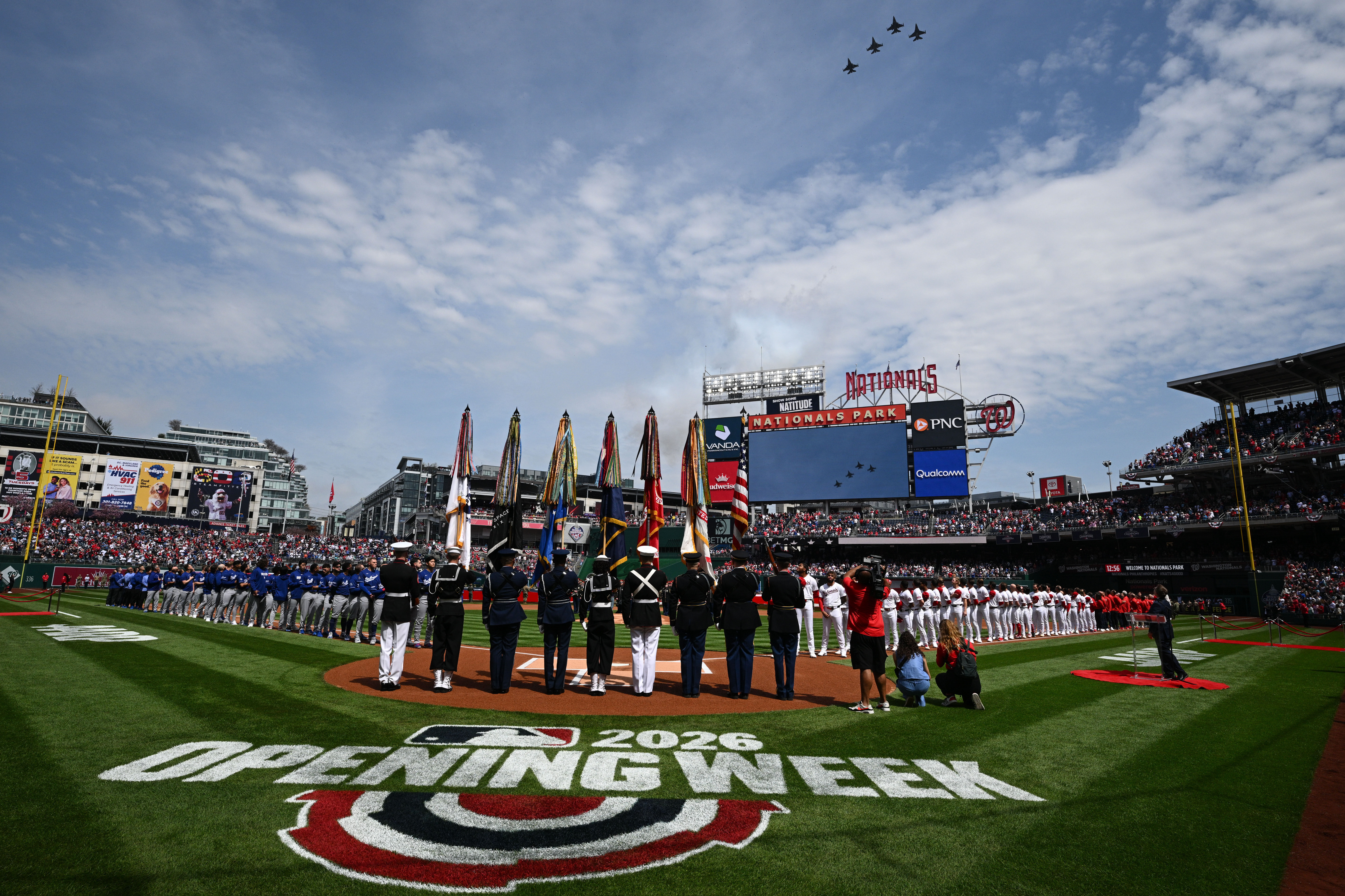 The Washington Nationals, right, and the Dodgers, left, stand on...
