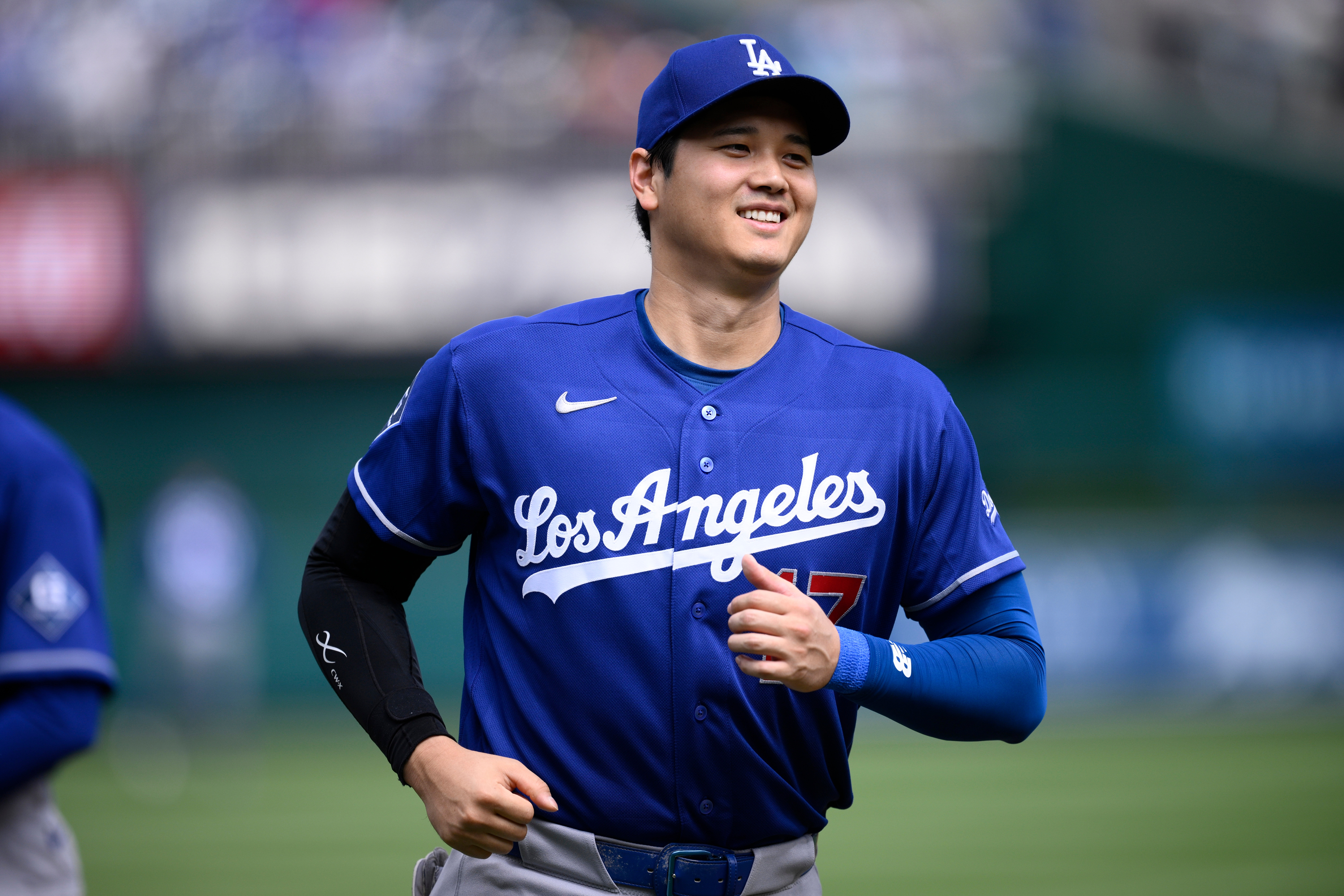 Dodgers star Shohei Ohtani smiles during player introductions before a...