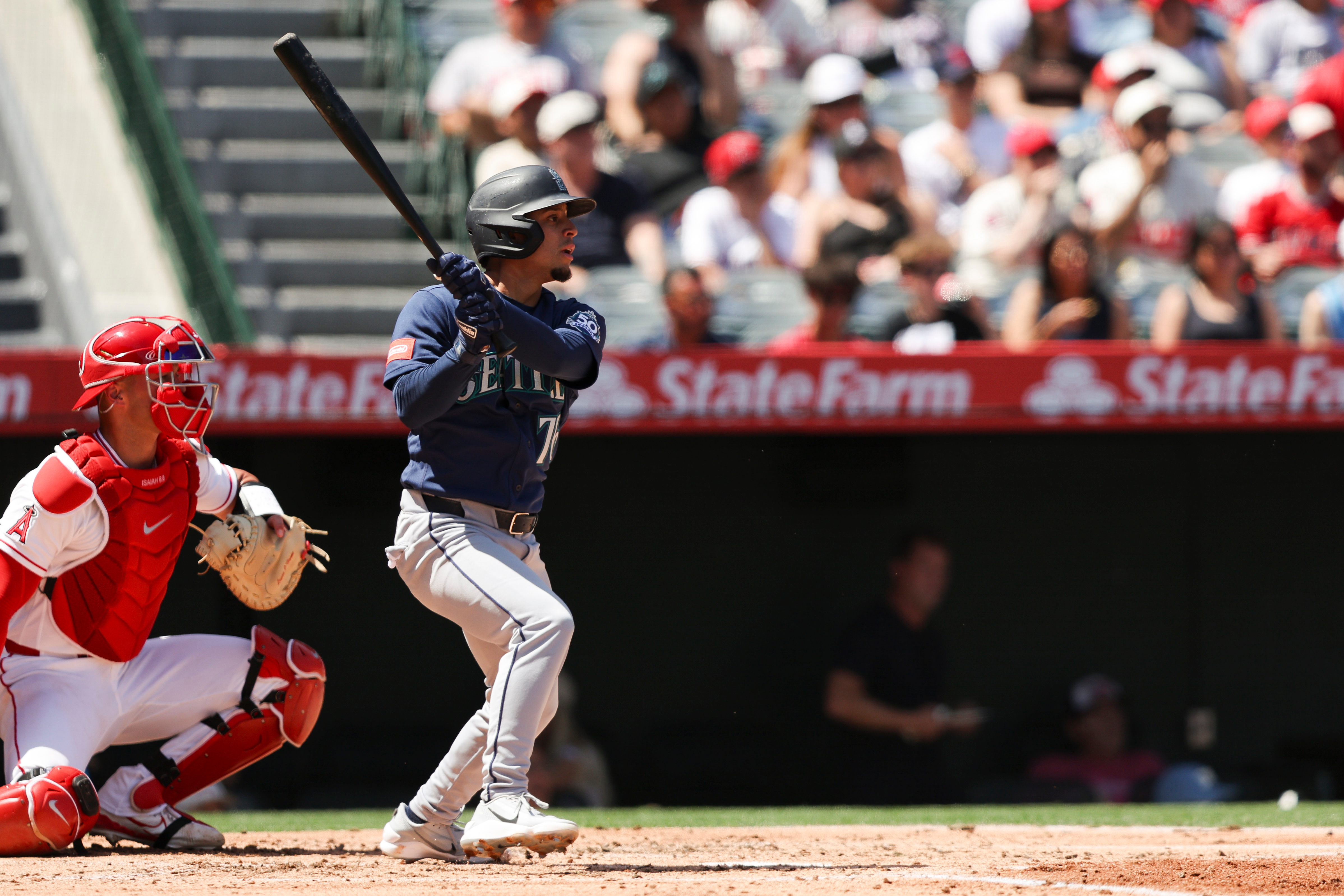 Seattle Mariners’ Leo Rivas follows through on an RBI single...