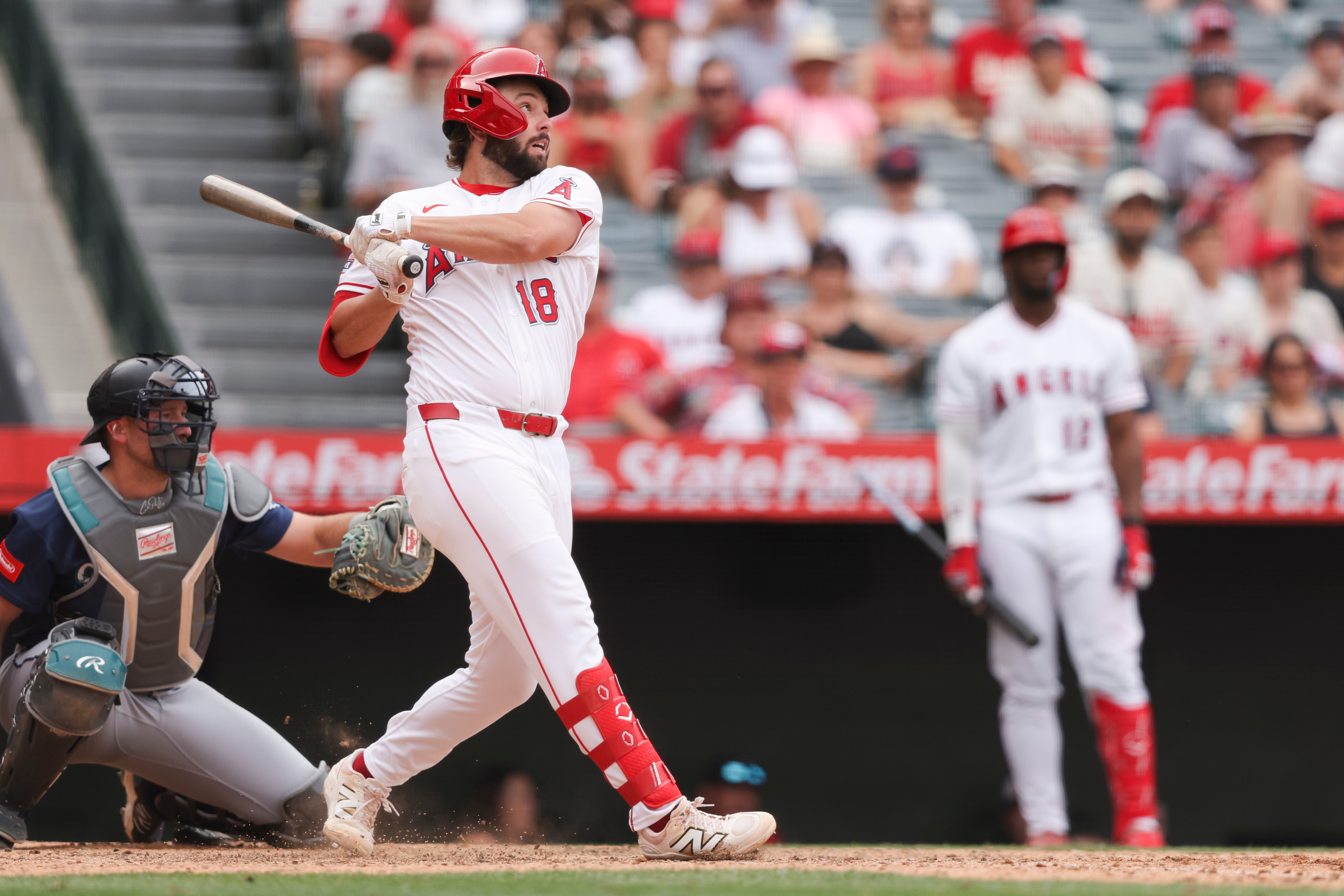 Angels’ Nolan Schanuel follows through on a swing after hitting...