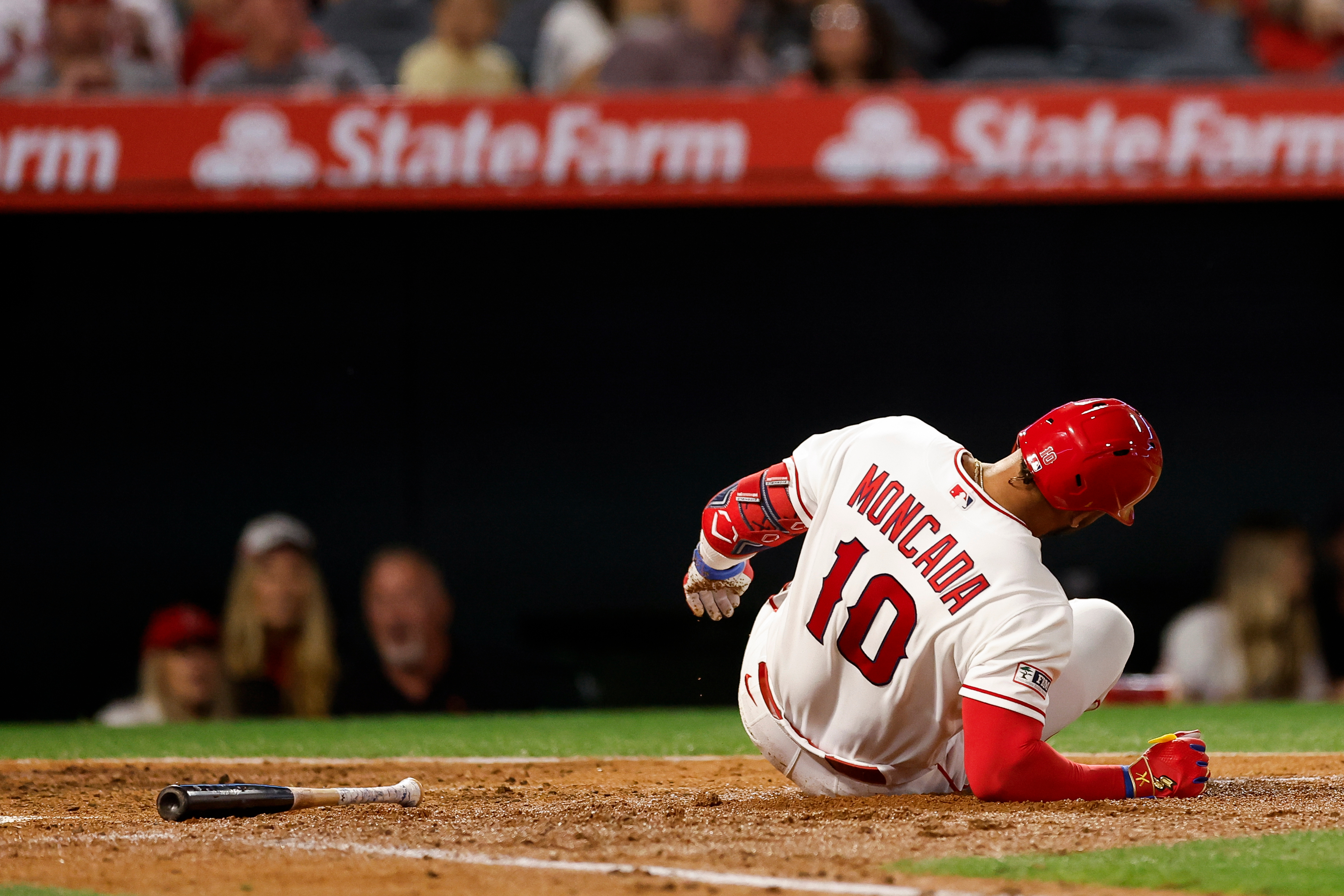 Angels designated hitter Yoan Moncada. reacts after getting hit by...