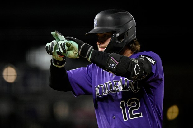 Colorado Rockies Kyle Karros draws a line with his fingers after hitting an RBI-single in the fifth inning of a baseball game against the Houston Astros, Monday, April 6, 2026, in Denver. (AP Photo/Geneva Heffernan)