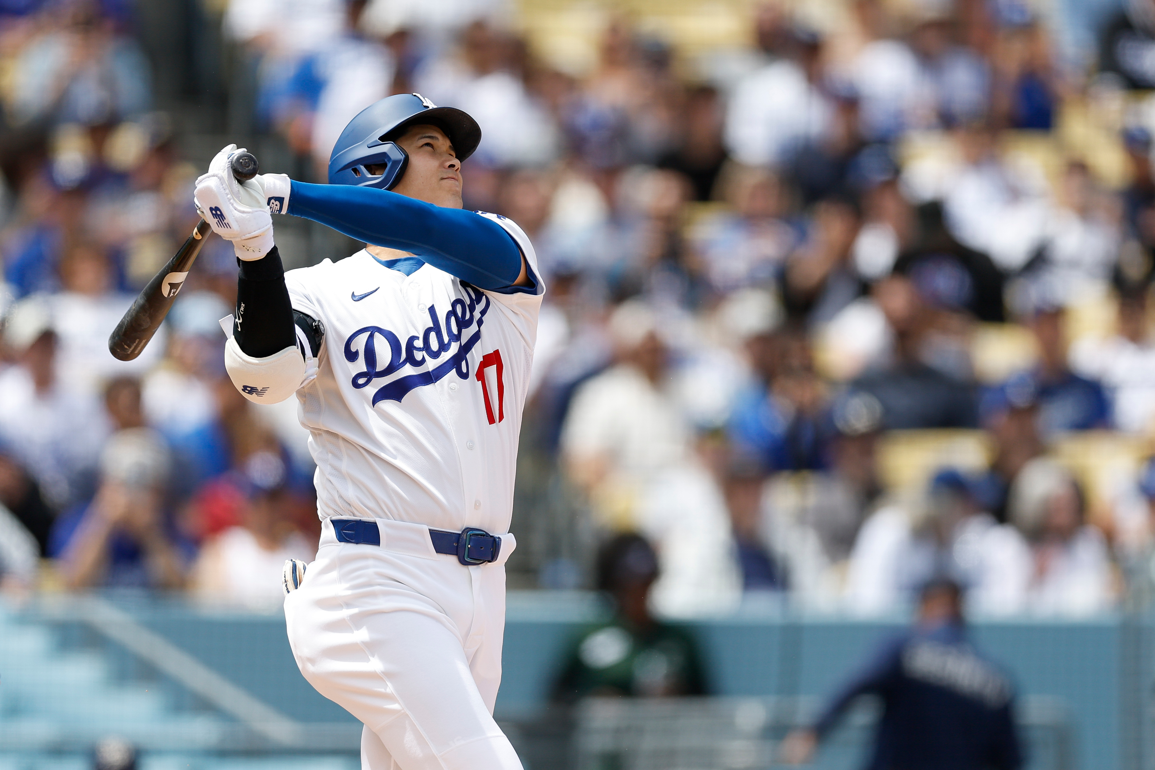 Dodgers designated hitter Shohei Ohtani watches his home run during...
