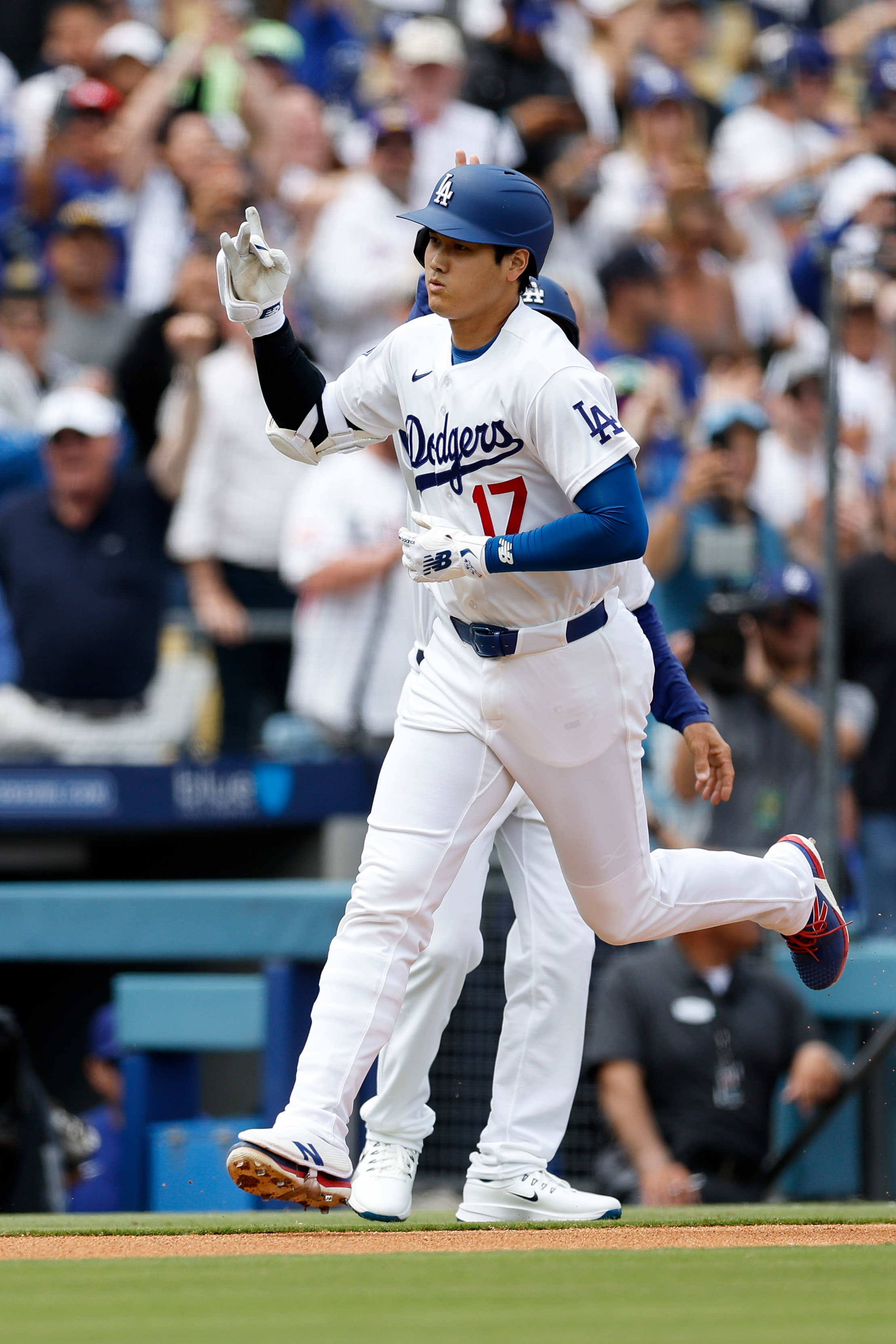 Dodgers designated hitter Shohei Ohtani (17) rounds the bases after...