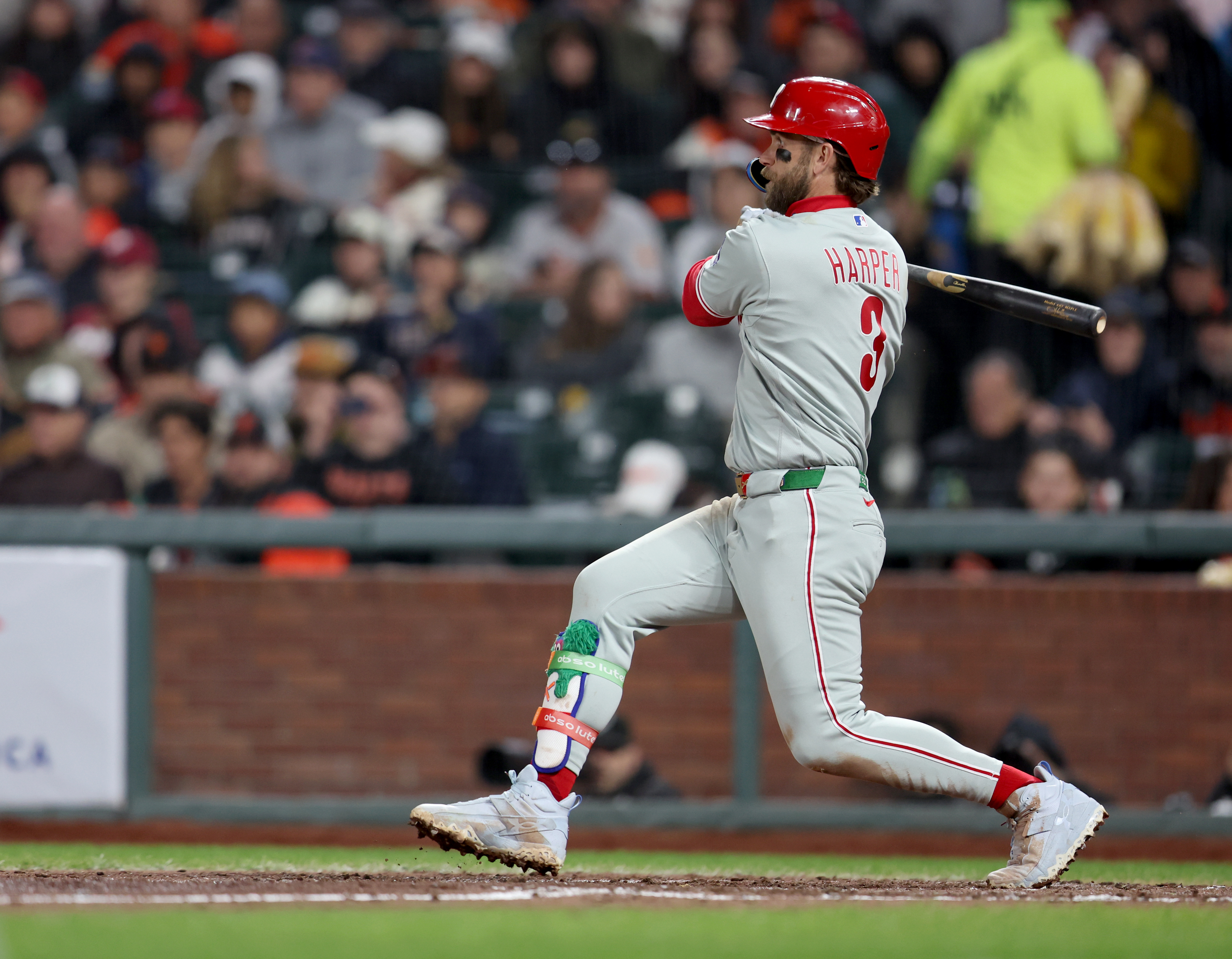 Philadelphia Phillies’ Bryce Harper #3 watches the flight of his...